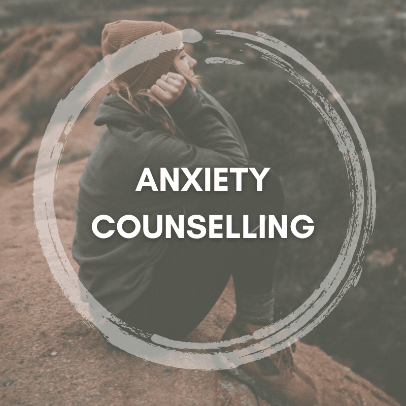 Person sitting on a rock contemplating, representing anxiety counselling services.