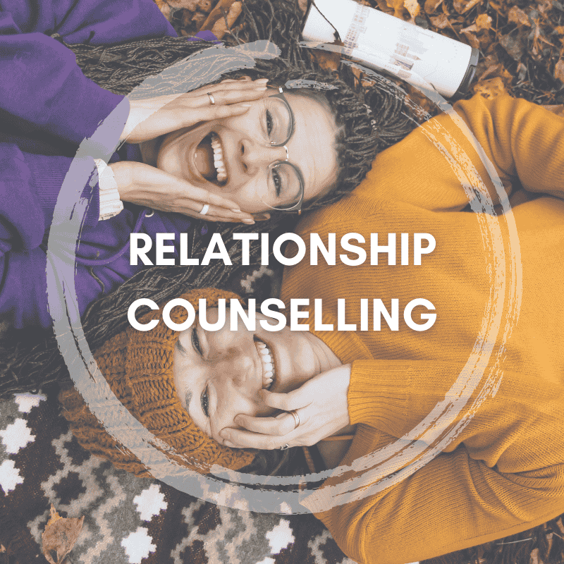 Two friends lying on a blanket, smiling and enjoying each other's company, representing relationship counselling services